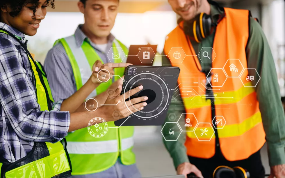 colleagues-discussing-data-working-tablet-laptop-with-architectural-project-construction-site-desk-officexa(1)