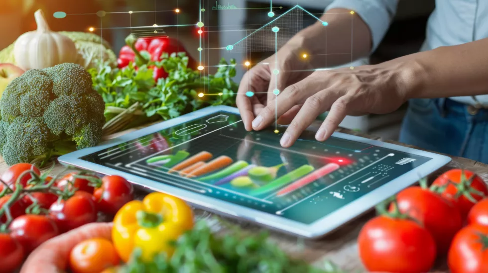 person-touching-tablet-with-vegetables-background