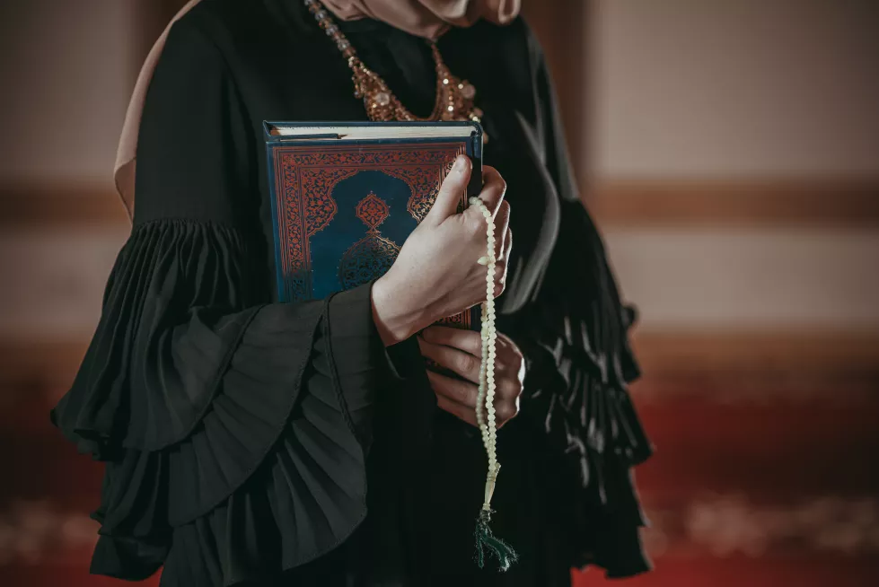 midsection-woman-holding-koran