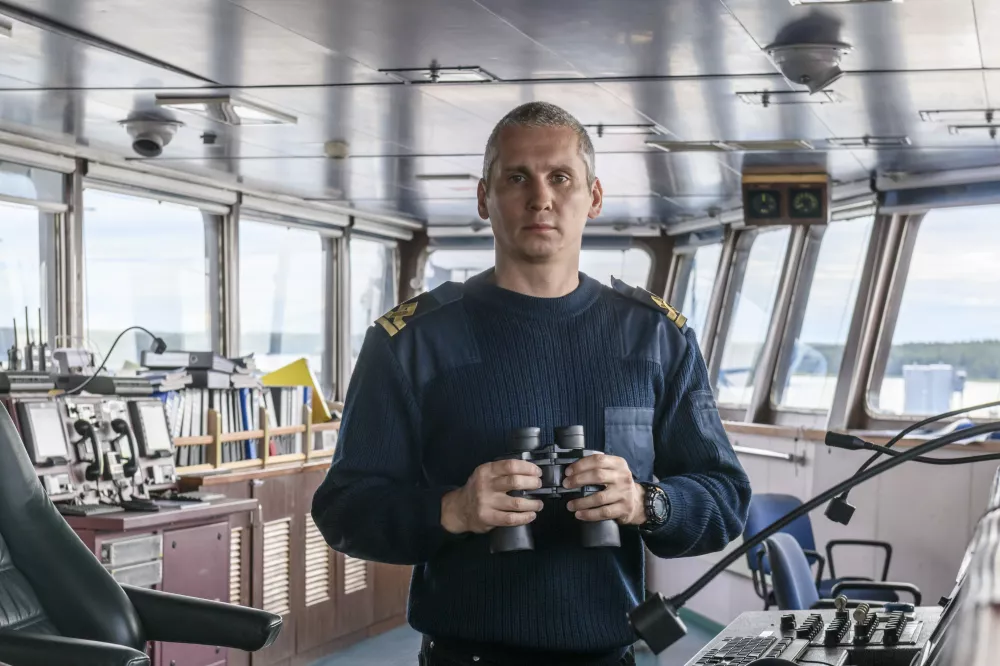 deck-officer-with-binoculars-navigational-bridge-seaman-board-vessel-commercial-shipping