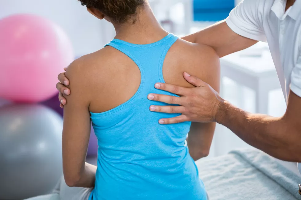 physiotherapist-giving-back-massage-female-patient