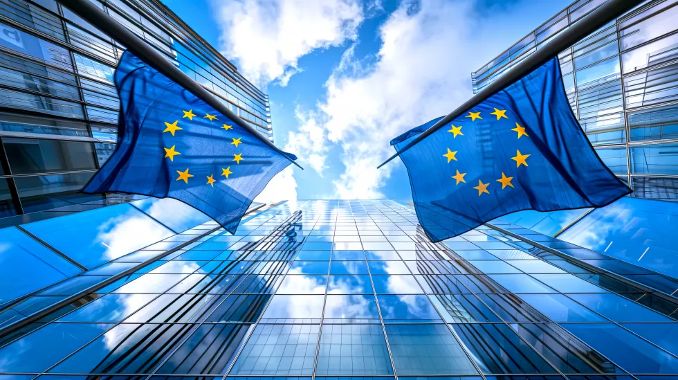 european-union-flags-reflected-modern-glass-buildings-against-blue-sky-captures-spirit-unity-european-identity-ideal-corporate-governance-eurelated-content-ai