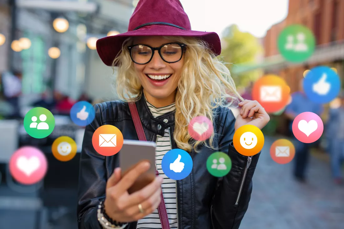 young-woman-with-mobile-phone-outdoors-concept-everyday-technology-usage