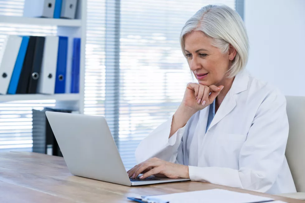 thoughtful-female-doctor-working-her-laptop