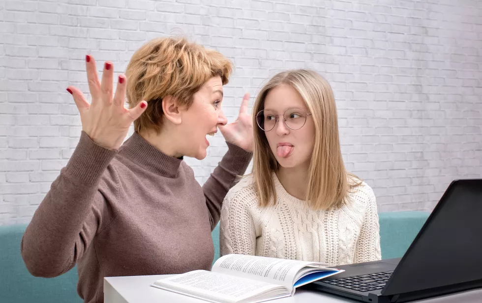mother-shouts-teenage-daughter-daughter-shows-tongue