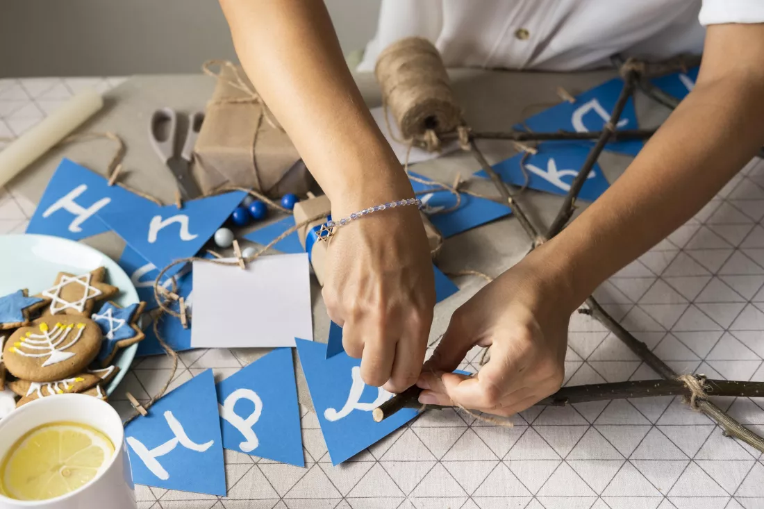 high-view-person-making-happy-hanukkah-garland