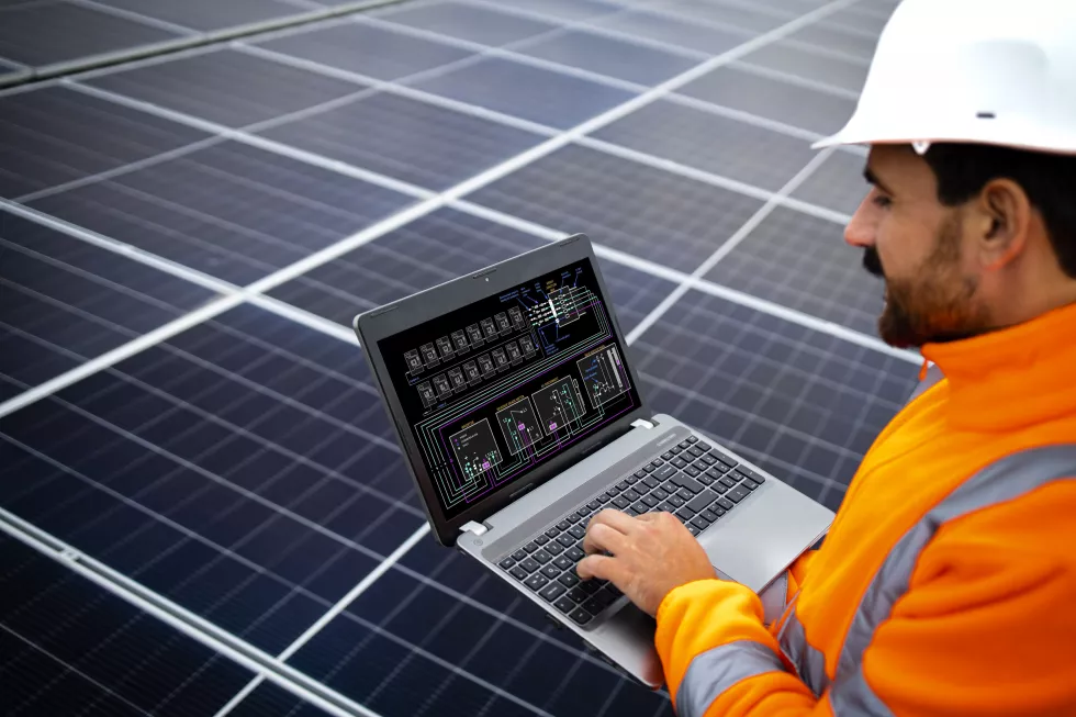 electrical-engineer-holding-laptop-computer-with-solar-panels-scheme-checking-productivity
