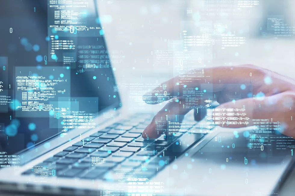 close-up-hands-using-laptop-with-creative-binary-coding-hologram-blurry-background-software-programming-code-double-exposure