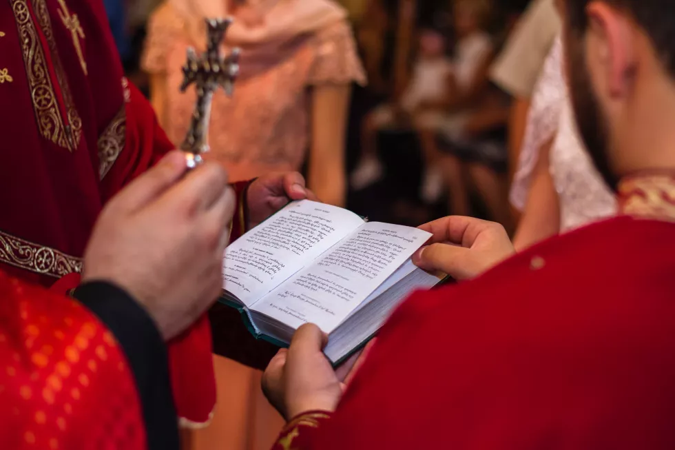 midsection-priest-reading-bible-church