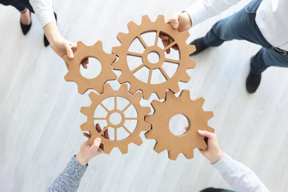 group-business-people-stacking-wooden-gears-top-view-teamwork-concept