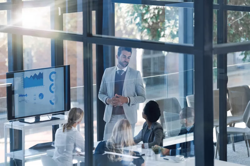 meeting-presentation-business-people-with-manager-screen-statistics-data-analytics-charts-by-window-speaker-man-speaking-employees-with-infographics-revenue-profit-monitor