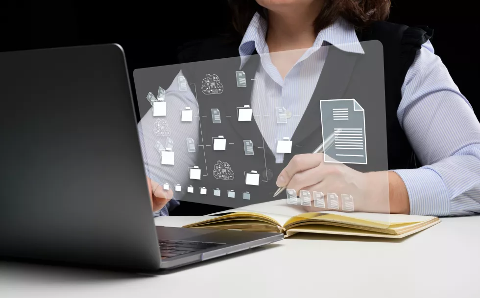 woman-sits-table-works-with-laptop-document-management-mystem-dms-software-automating-archiving-efficient-management-information-files