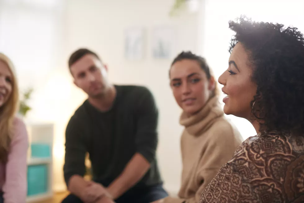 woman-speaking-support-group-meeting-mental-health-dependency-issues-community-space