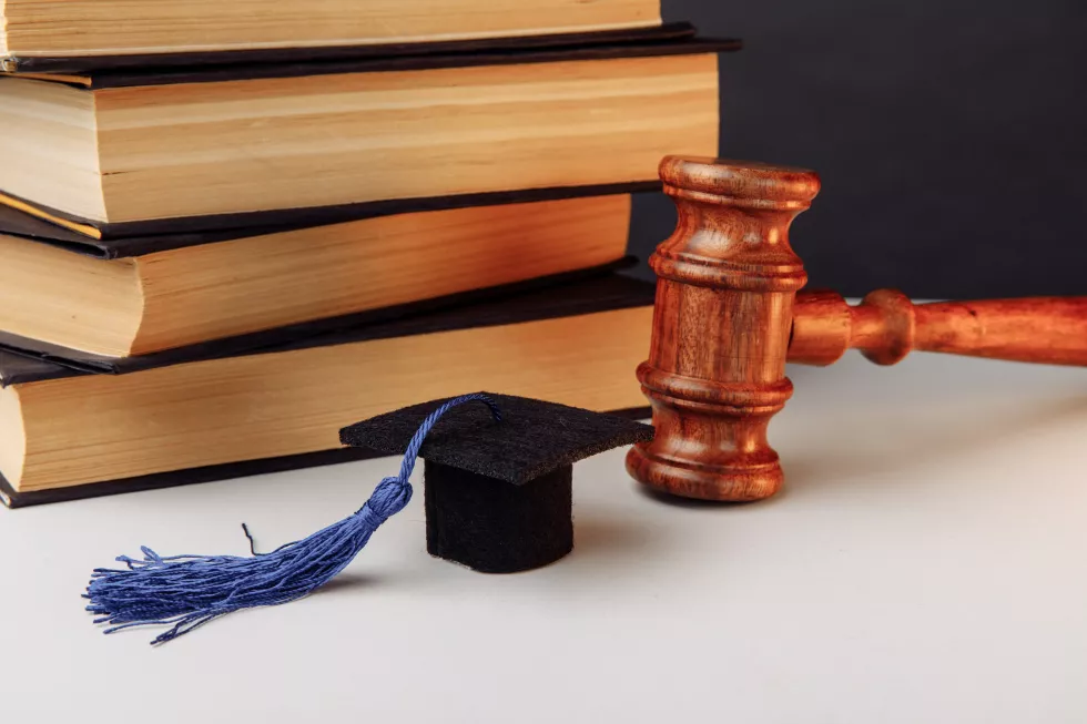 stack-books-academic-cap-wooden-gavel