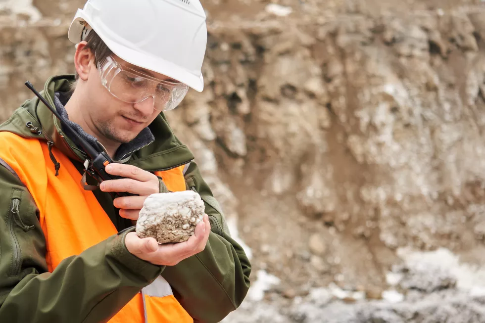 man-geologist-examines-mineral-sample