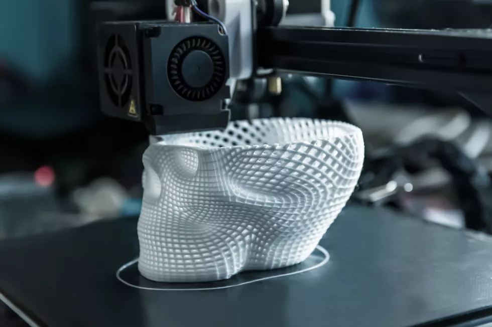3d-printer-prints-white-plastic-model-skull-modern-technology