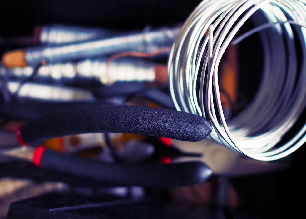 curled-up-wire-with-pliers-table