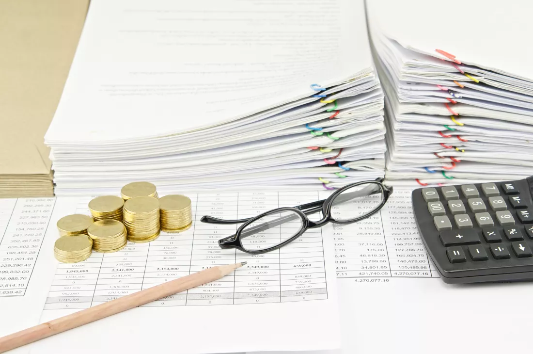 stack-coins-documents-by-calculator-table-office