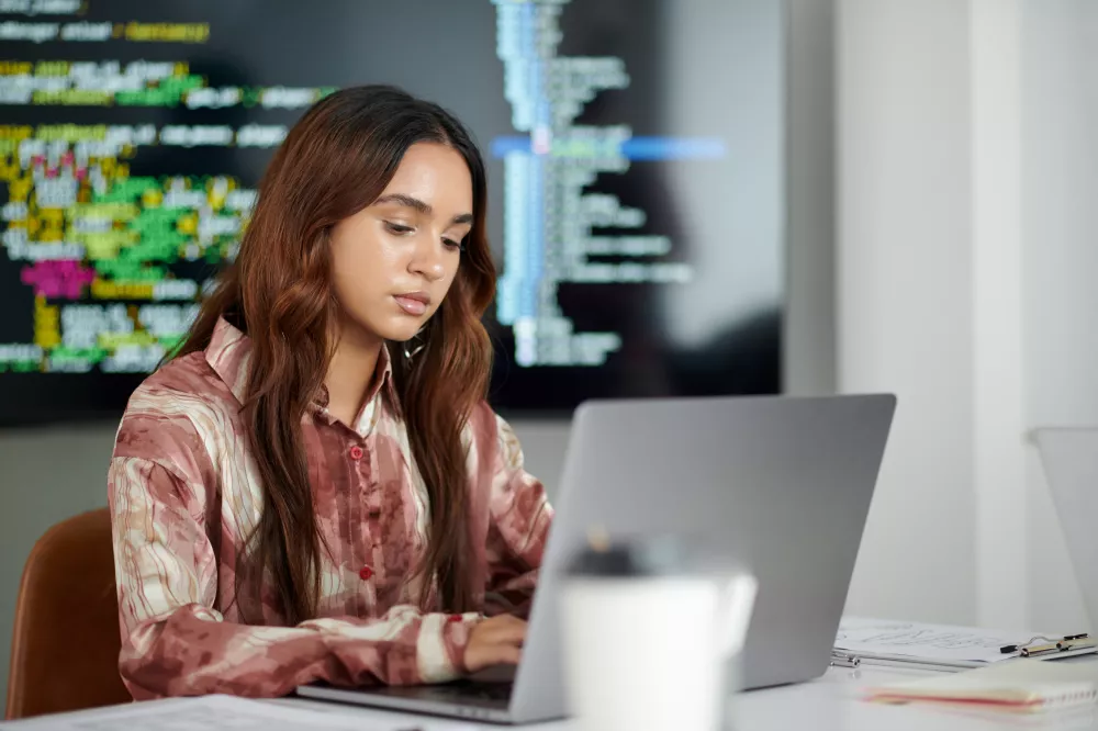 portrait-young-developer-working-laptop-office-it-company