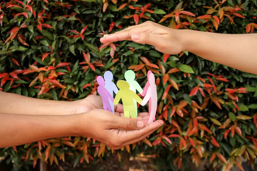 arrangement-paper-human-figures-making-circle-protective-hands-gesture(1)