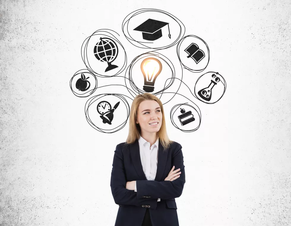 blond-woman-with-crossed-arms-education-sketches-concrete-wall