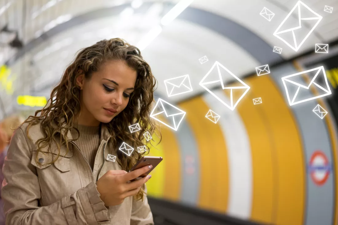 woman-using-mobile-phone-tube-underground-station-london
