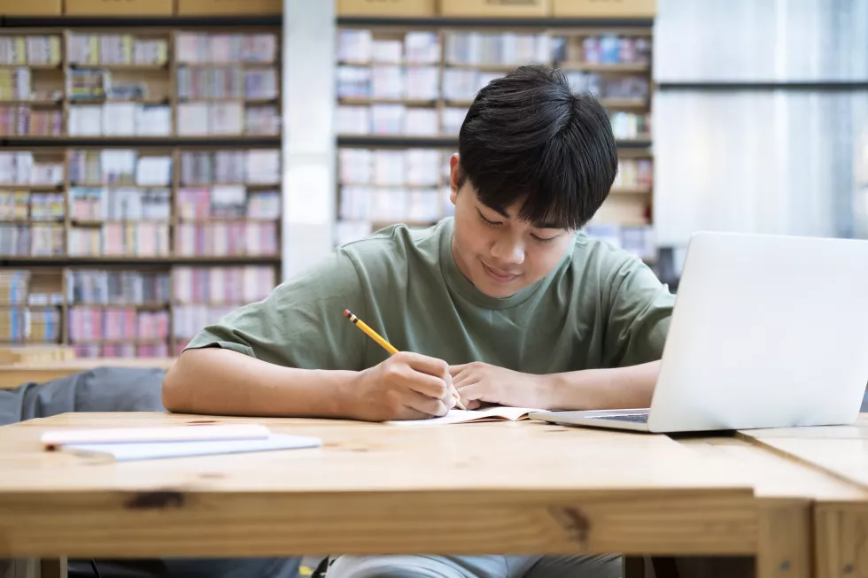 young-collage-student-using-computer-mobile-device-studying-online-education-online-learning