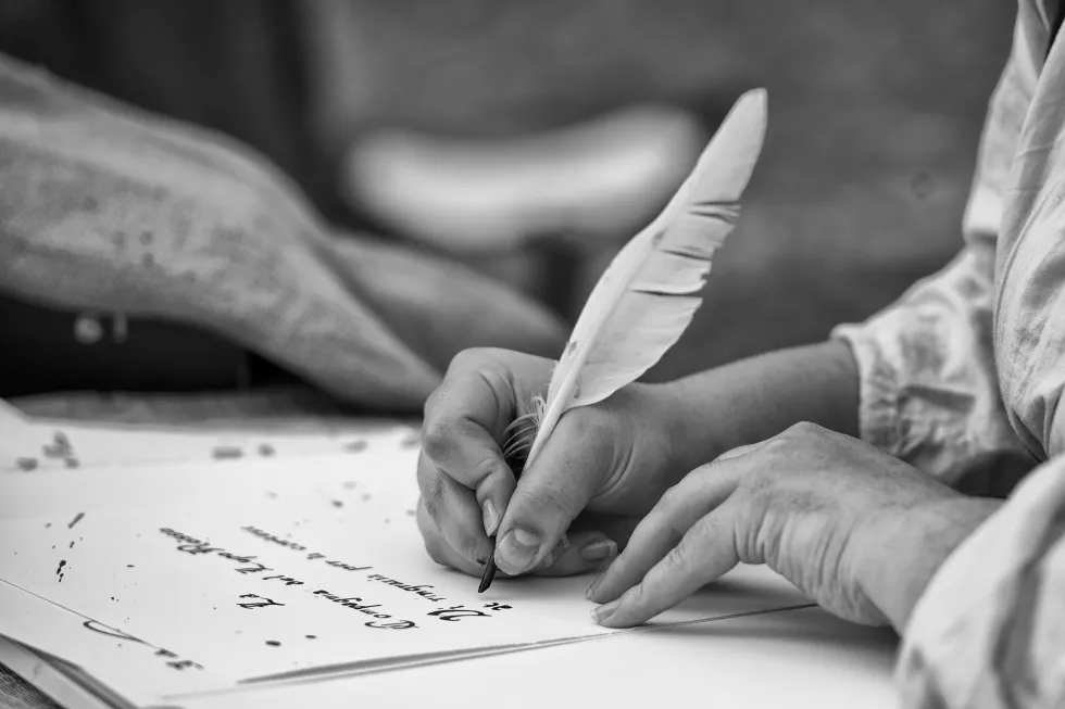 hands-writing-letter-with-plume