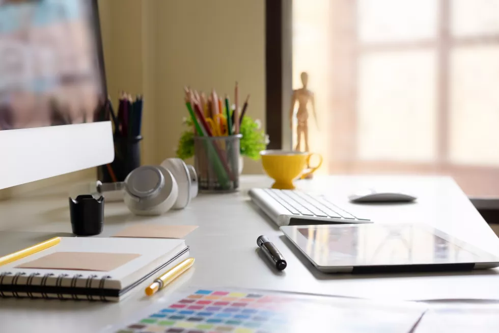 side-view-modern-office-workplace-with-digital-tablet-notepad-colorful-pencils-computer