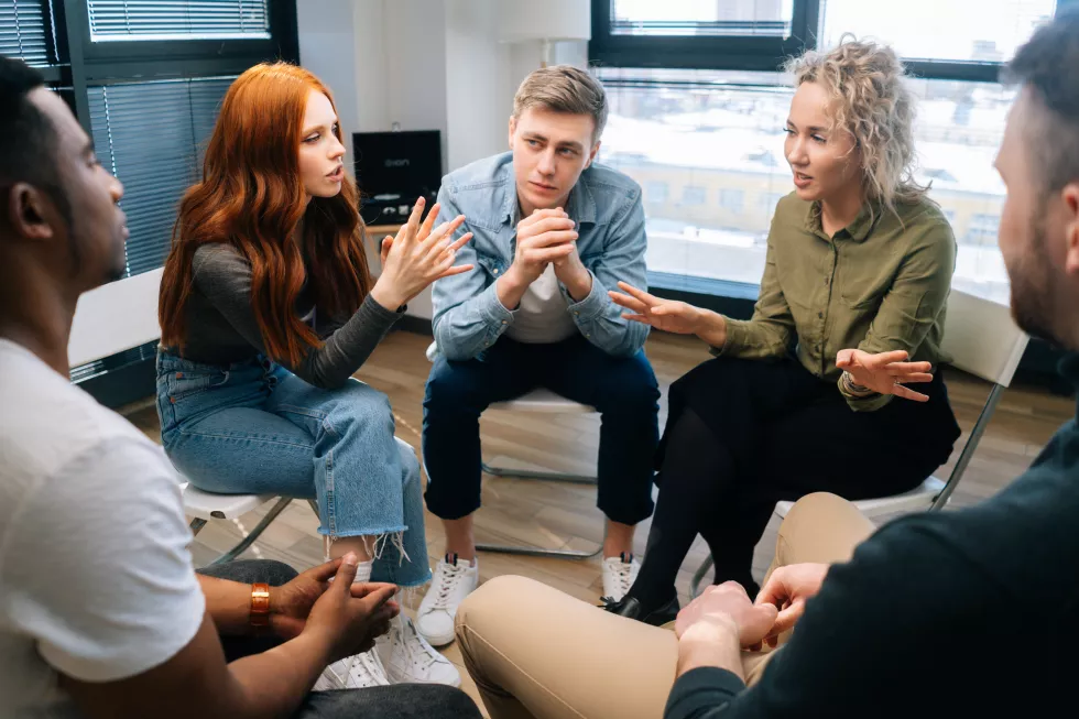 friendly-multiethnic-business-team-share-ideas-brainstorming-background-window-young-creative-colleagues-working-together-teamwork-discuss-project-plan-office(1)