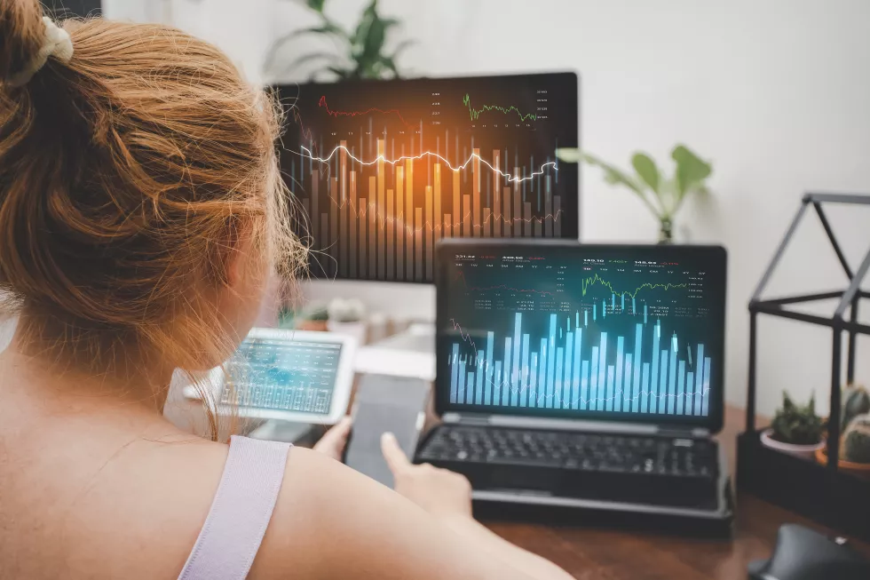 asian-young-woman-interacting-with-laptops-phones-tablets-with-featuring-stock-tickers-graphs-cryptocurrency-new-trading-platforms-ideas-perspectives-stock-investment-technology