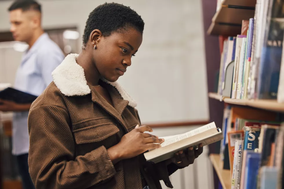 education-book-black-woman-reading-library-university-college-school-learning-studying-research-scholarship-gen-z-african-girl-focused-knowledge-growth-student-development