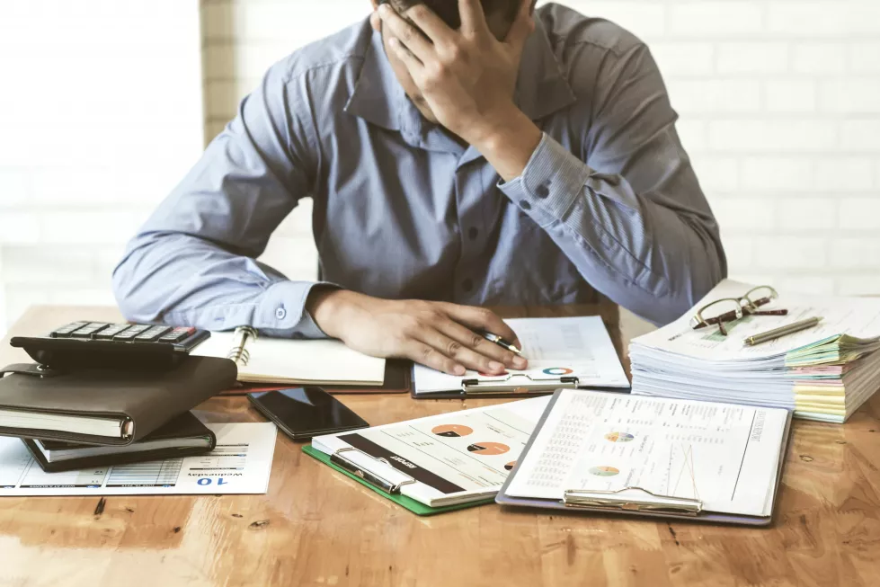 frustrated-middle-aged-businessman-sitting-office-desk(1)