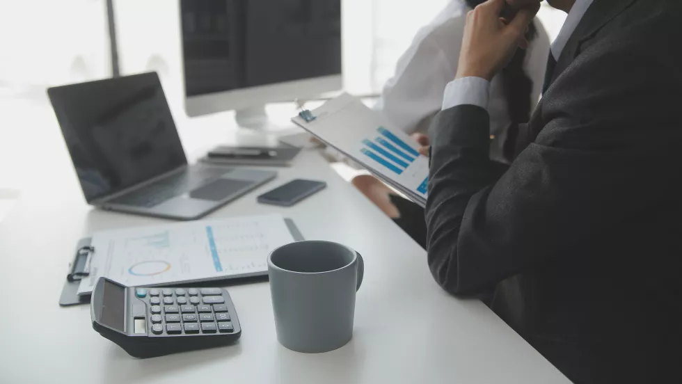 close-up-business-woman-using-calculator-laptop-math-finance-wooden-desk-tax-accounting-statistics-analytical-research-concept-2