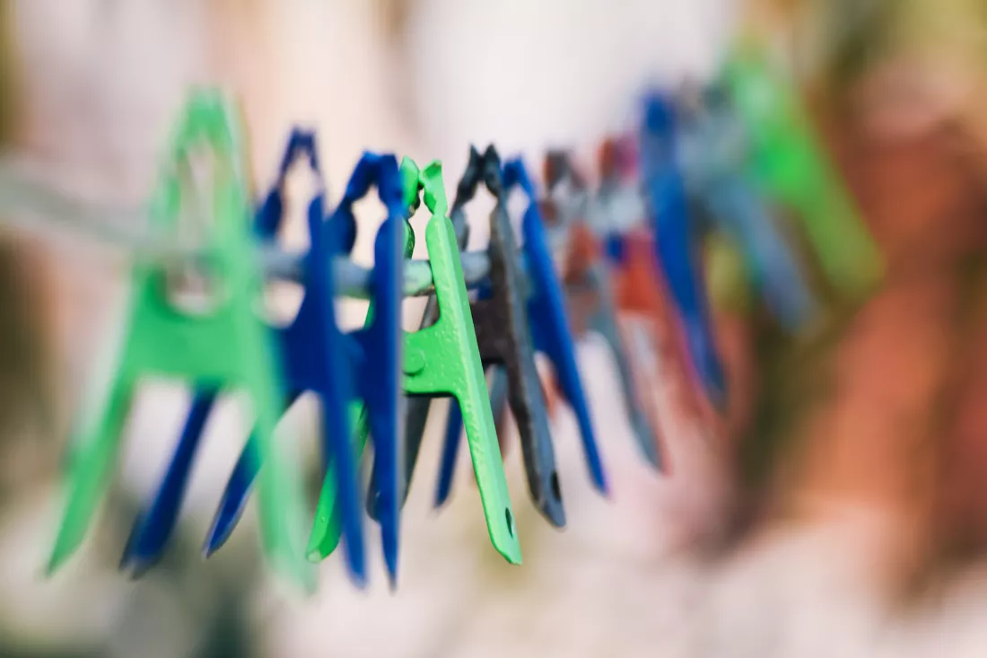 close-up-multi-colored-clothespins-hanging-clothesline