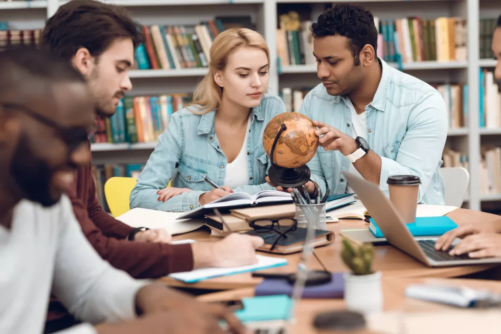 group-ethnic-multicultural-students-sitting-table