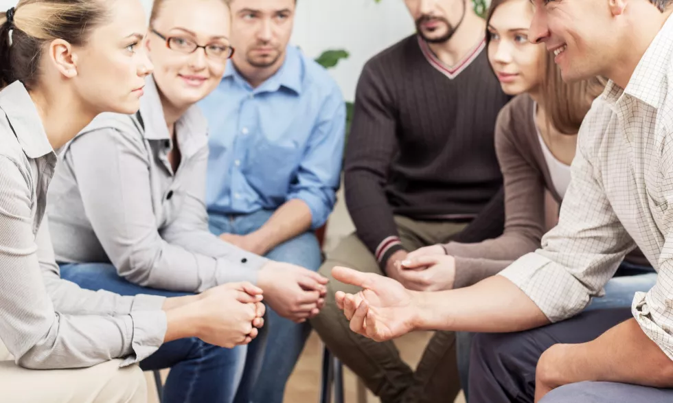 diverse-people-sitting-circle-holding-hands-group-therapy-session