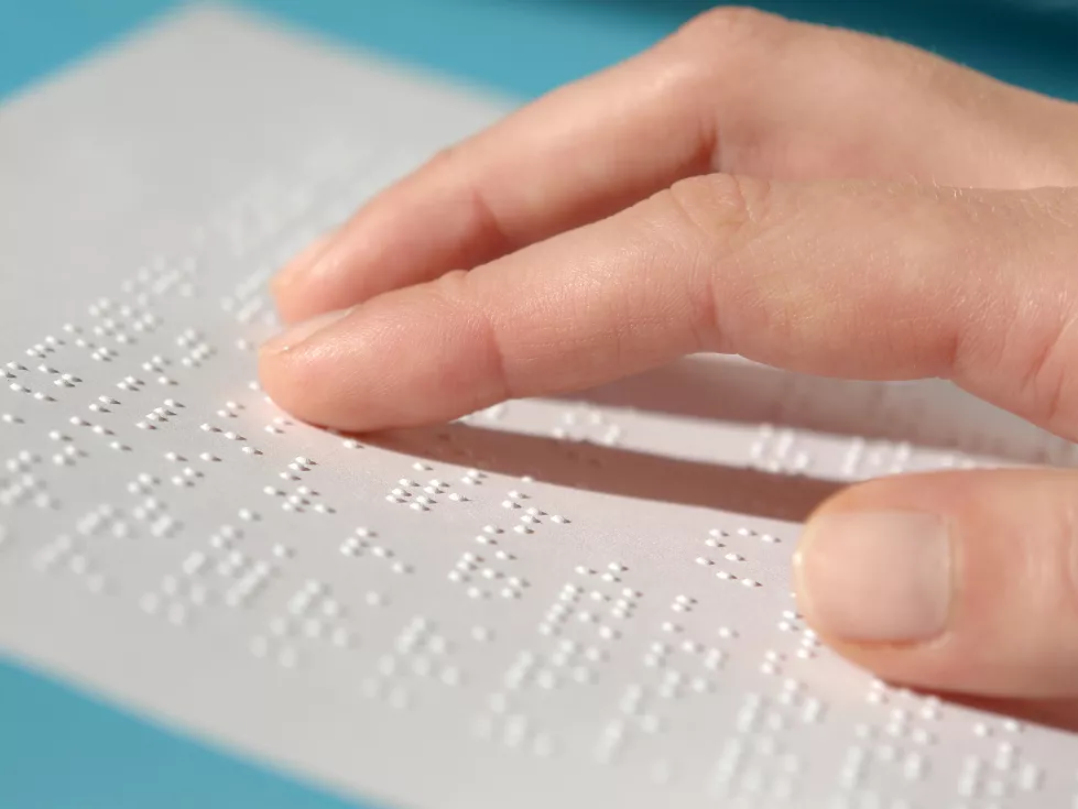 cropped-hand-blind-woman-reading-braille