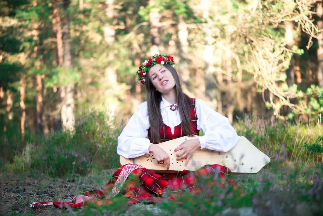 beautiful-musician-wearing-flowers-wreath-while-playing-string-instrument-forest