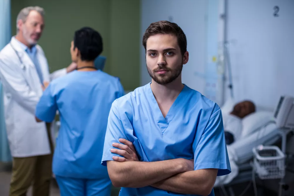 portrait-male-nurse-standing-ward