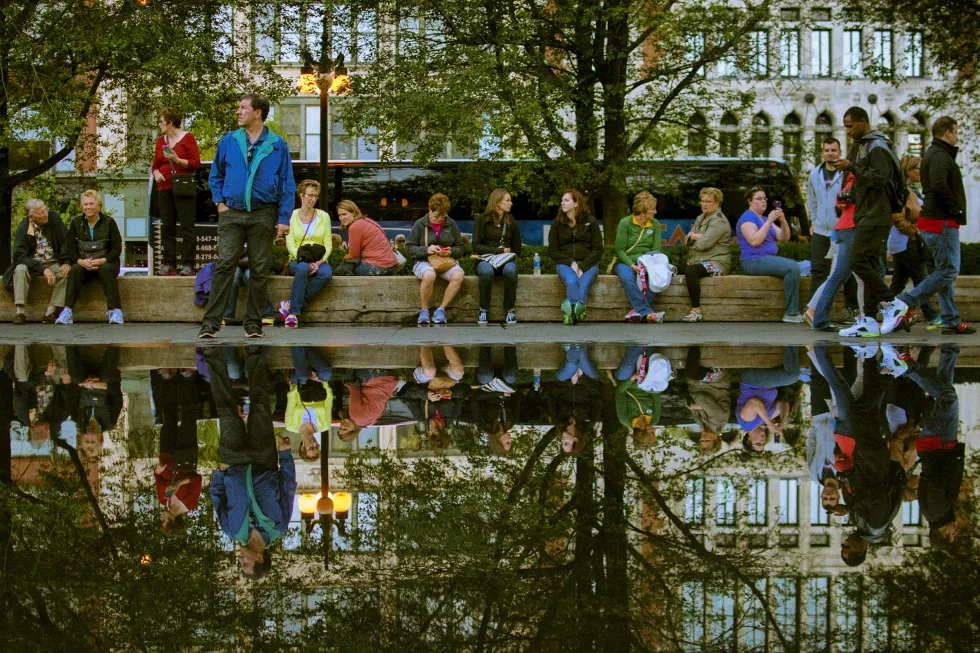 people-sitting-park-with-reflection-puddle