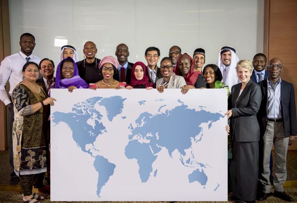 diverse-people-show-world-map-board-placard
