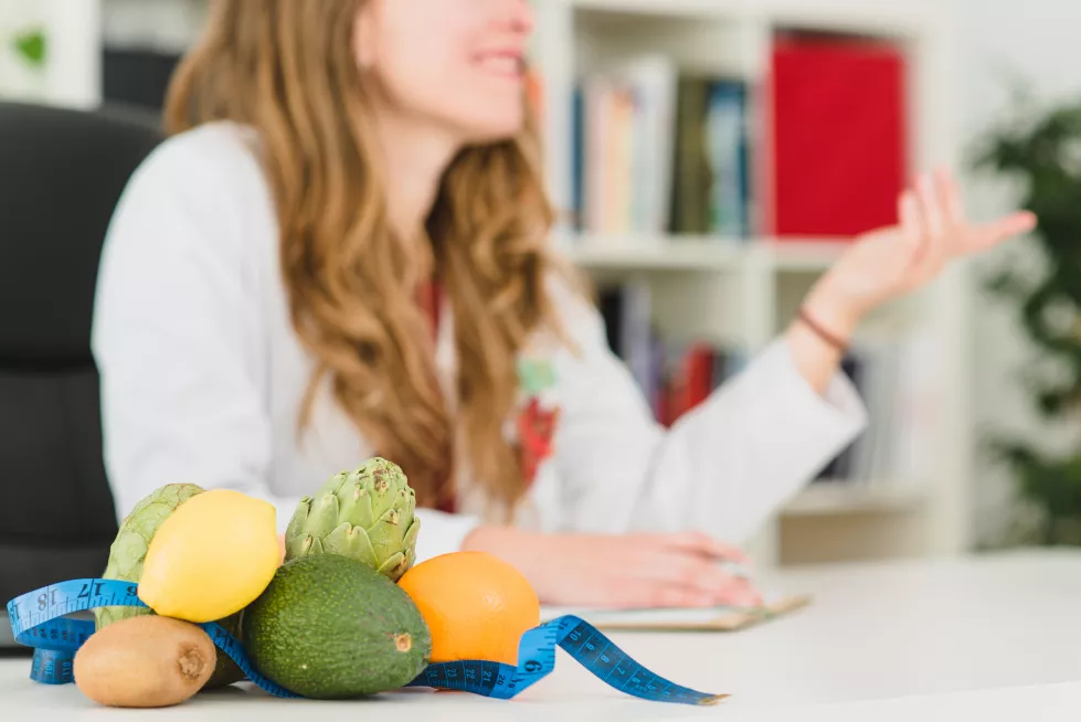 nutritionist-desk-with-healthy-fruit-measuring-tape-dietitian-working-diet-plan-concept