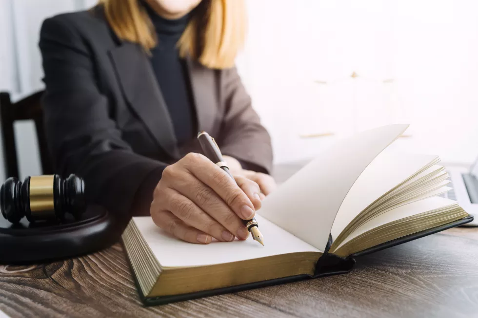 justice-law-conceptmale-judge-courtroom-with-gavel-working-with-computer-docking-keyboard-eyeglasses-table-morning-light-2