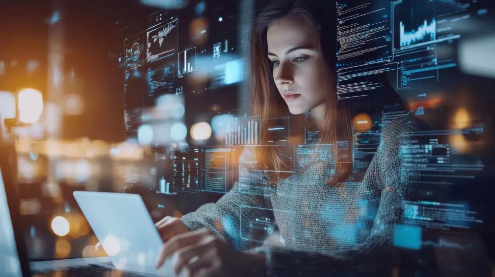 focused-woman-analyzing-data-laptop-with-virtual-graphics-overlay