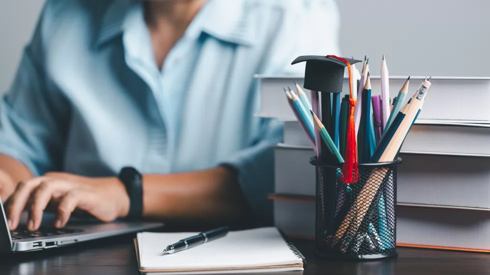 education-concept-close-up-female-student-make-notes-hand-typing-laptop-study-online-computer-from-home-woman-typing-computer-talking-distant-webcam-virtual-zoom-call-laptop