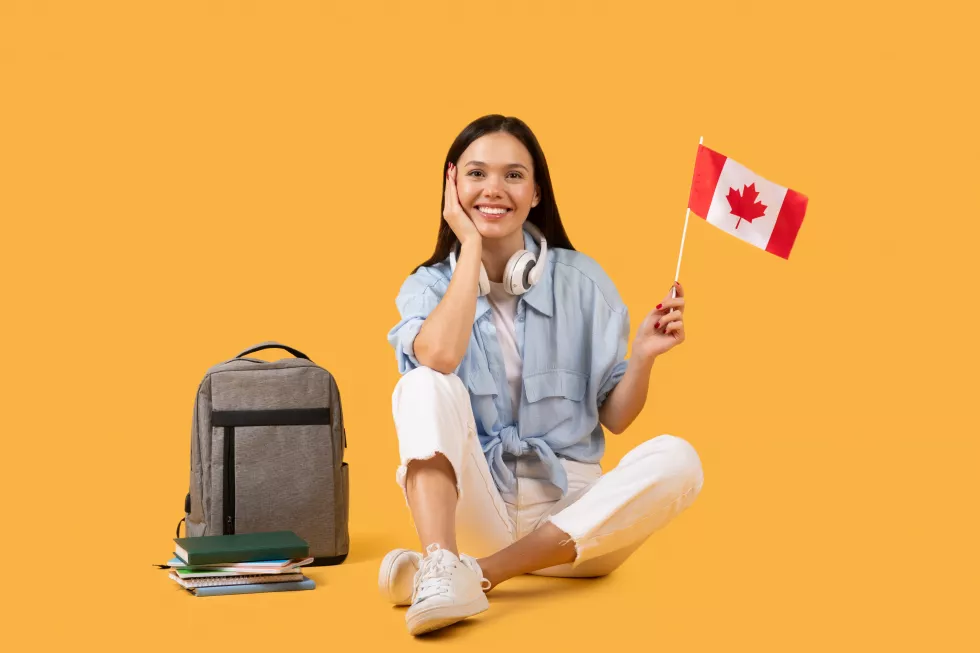 content-lady-student-with-canadian-flag-headphones-yellow-background