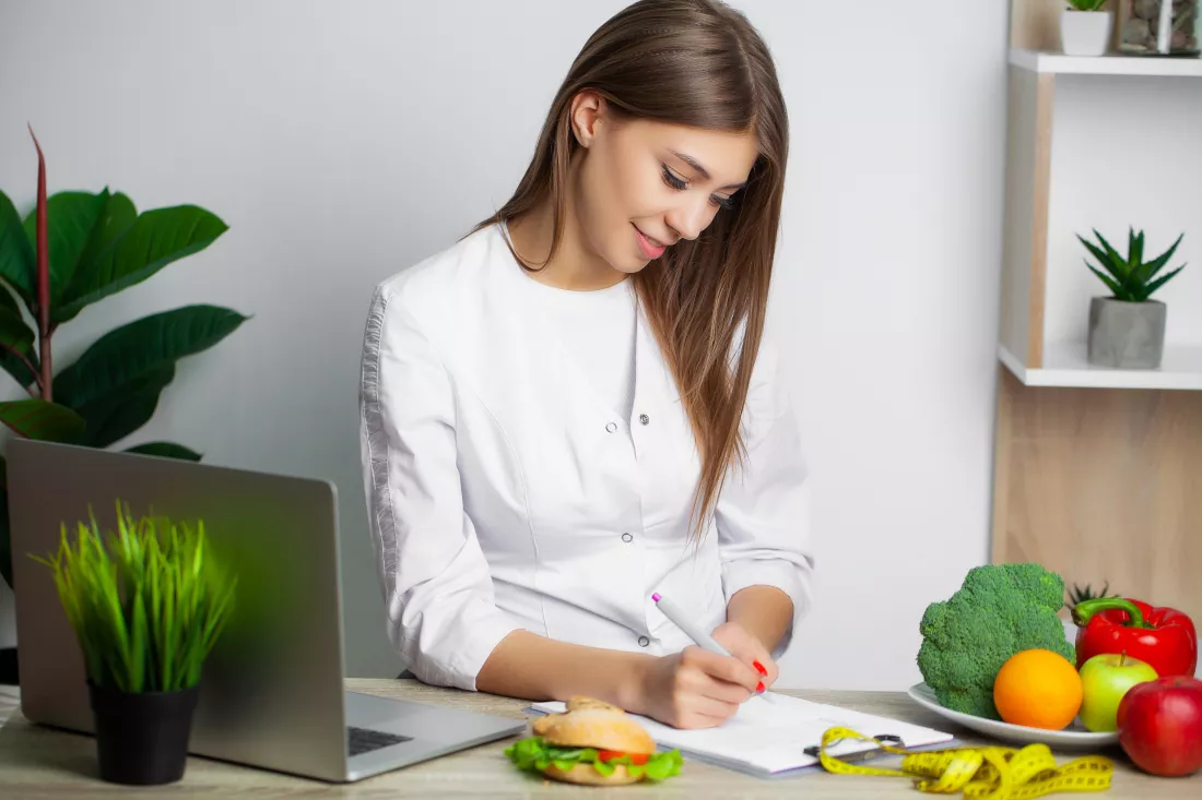 woman-white-coat-nutritionist-writes-healthy-diet-program-weight-loss