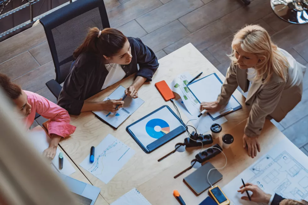 senior-female-ceo-business-people-having-project-discussion-briefing-boardroom-table