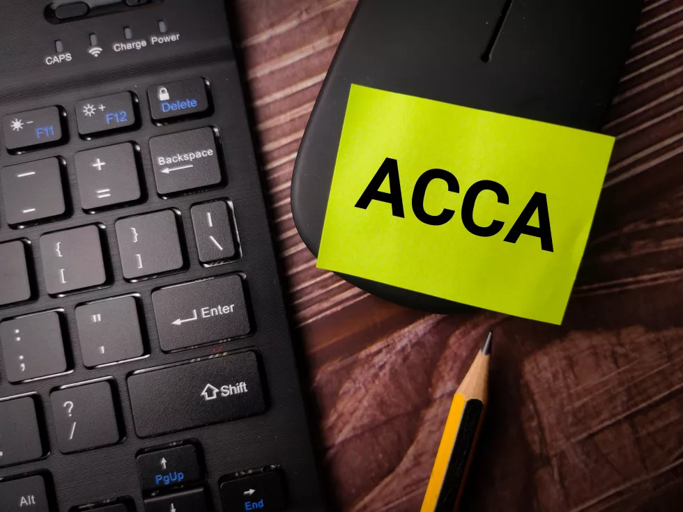 wireless-keyboard-mouse-with-word-acca-wooden-background-copywriting-formula-concept